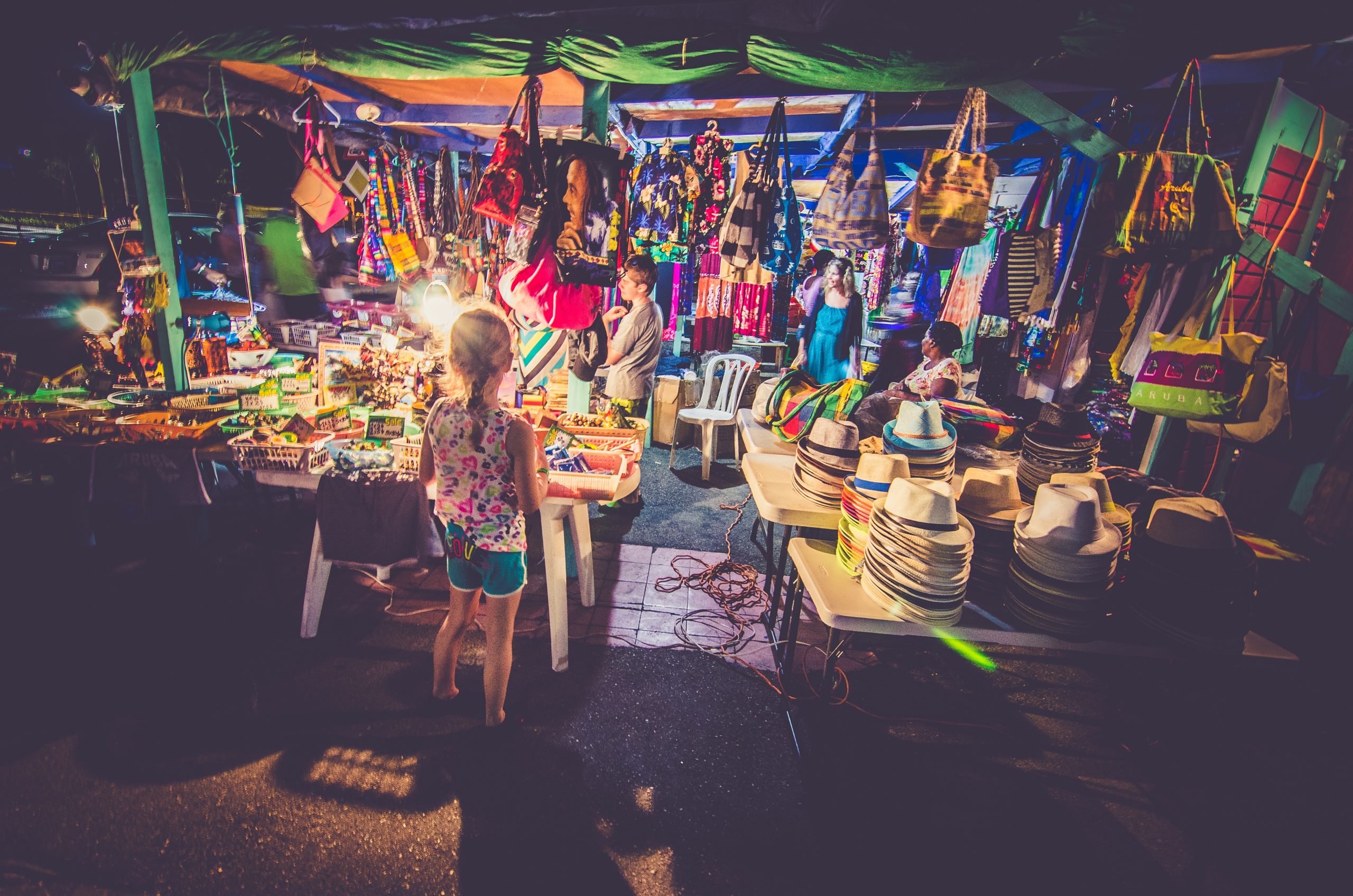 This a picture of a girl inspecting a market stall for an article called What makes an excellent Market Intelligence and OSINT Analyst by Octopus Competitive Intelligence consultancy for Competitor Analysis and market intelligence services. Market Intelligence Definition