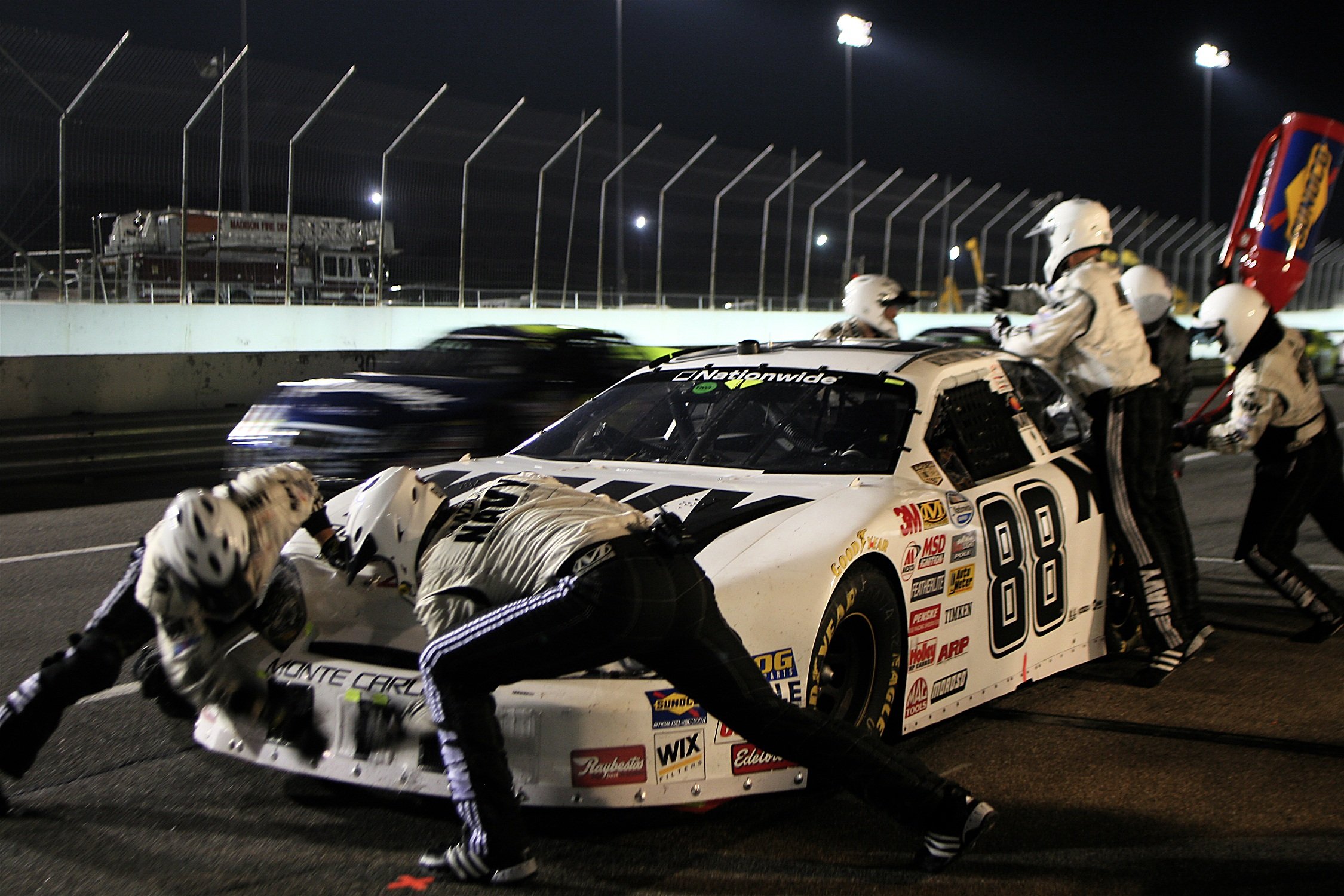 This is an image of a racing car in a pitstop for an article called the eight parts of Intelligence-driven Competitive Intelligence by Octopus Competitive Intelligence providing competitor analysis to you. Outpace Your Competitors in Business with 8 strategies. Data-Driven Investments and Competitive Intelligence as a Decision-Making Tool