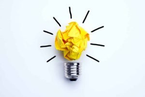 This is a picture of a abstract bulb with the core made of yellow paper for an article called the 8 Best ways to deal with recurring business problems by Octopus Competitive Intelligence