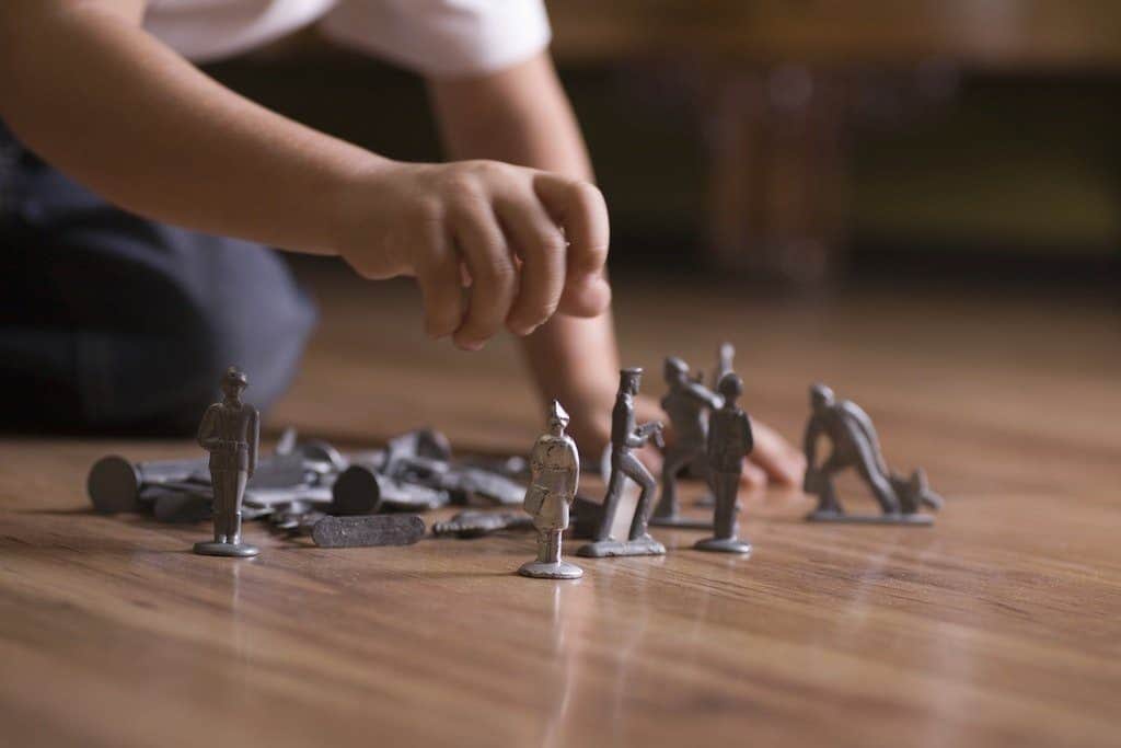 The is a Picture of a boy playing with toy soldiers on a wooden floor for an article by Octopus Intelligence. We isolate your problems, reduce risk and uncertainty and deliver intelligence-led answers and innovative solutions. Dedicated to help you win.Respond to business problems by adapting quickly