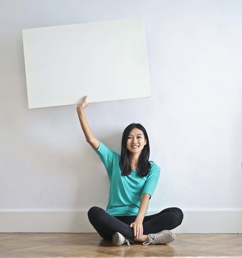 This is picture of a Girl holding a frame up for an article entitled Top 5 Business Frameworks according to Strategy Consultants By Octopus Intelligence. Solving problems with Competitive Intelligence, common sense and market analysis. Delving into the Essence of Competitor Analysis Frameworks