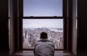 This is a picture of a man looking out of a New york hotel for an article Outsourcing Competitive Intelligence is a good idea by Octopus Competitive Intelligence, Competitor Analysis Research by Octopus is a Competitive Intelligence Competitor Analysis & Strategy consulting firm focused on creating certainty, insight, competitive advantage & significant growth. Researching your business idea is a process worth doing.