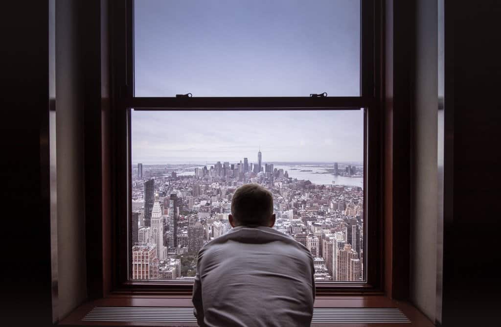 This is a picture of a man looking out of a New york hotel for an article Outsourcing Competitive Intelligence is a good idea by Octopus Competitive Intelligence, Competitor Analysis Research by Octopus is a Competitive Intelligence Competitor Analysis & Strategy consulting firm focused on creating certainty, insight, competitive advantage & significant growth. Researching your business idea is a process worth doing.