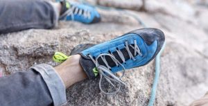 This is a picture of a rock climbers feet and boots for an article called Which industries use Market Intelligence and why? By Octopus Market Intelligence company. We answer the questions with Market Intelligence, Due Diligence and business development