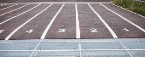 This is a picture the start line for a 100m race for an article called What market Intelligence projects to do first by Octopus market Intelligence answering questions you need to ask with Competitor Analysis