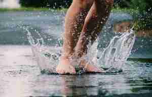 This is an image of a childs feet jumping into a puddle of water for a post called Director of Markets and Competitive Intelligence at SUEZ Water Technologies & Solutions Answers the Questions by Octopus is a Competitive Intelligence Competitor Analysis & Strategy consulting firm focused on creating certainty, insight, competitive advantage & significant growth. The Future of Foot Care: Innovative Tech Solutions for Managing Sweaty Feet