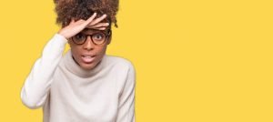 This is a picture of a young woman wearing glasses over isolated background very happy and smiling looking far away with hand over head for an article called How researching your competitors activities can give you Competitive Advantage by Octopus Competitive Intelligence Competitor Analysis focused on creating certainty