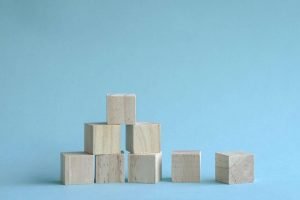 This is a picture a set of wooden block been placed on top of each other for an article called How to Beat Your Competition With Robust Competitor Analysis by Octopus Competitive Intelligence Competitor Analysis focused on creating certainty