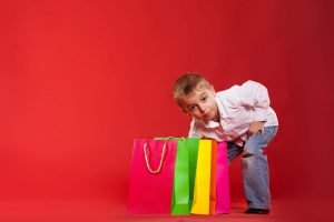 This is an image of a child taking a sneaky look through gift bags for an article called How Competitive Intelligence Helps With Strategic Inflexion Points by Octopus Competitive Intelligence Competitor Analysis focused on creating certainty. What are the main points of competitors analysis?