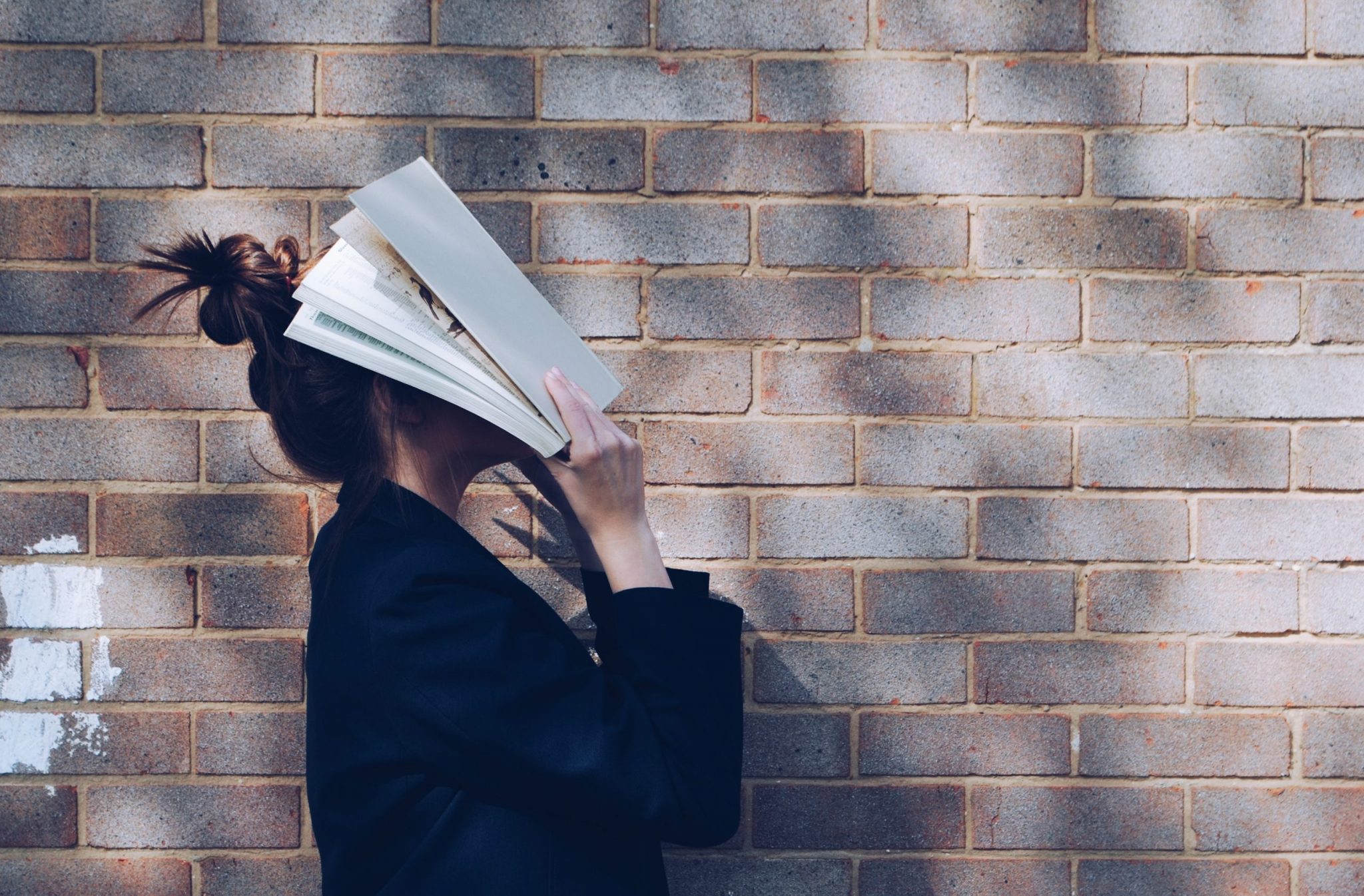 This is a picture of girl with a magazine on her face for a page called Download Request -Thank You by Octopus Competitive Intelligence consulting agency Benchmarking Your Business with Market Analysis. What is a competitive analysis? and how do you conduct one?