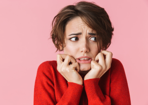 This is an image of a scared women in a red jumper for an article called Signs your industry is being Disrupted and how competitive intelligence helps by octopus competitive intelligence agency competitive intelligence solutions and market intelligence company