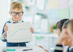 This is an image of a boy with a graph for an article called Examples of Competitive Intelligence to help your competitive advantage by Octopus competitive intelligence agency and market insights consultancy. How Do You Enable Competitive Advantage? Strategic Recall: How to Train Your Brain Like a Behaviour Analyst