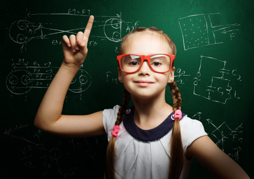 This is an image of a girl in red glasses infront of a blackboard for an article called Analysing Your Competitive Landscape Using Game Theory by octopus competitive intelligence agency market intelligence company and competitor intelligence solutions. Is It Possible to Make a Living from Internet Gaming?