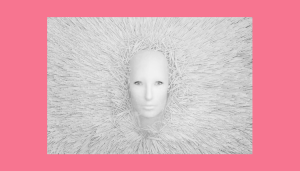 This is an image of a mask emerging from white shredded paper for an article called What Are the Primary Goals of Competitive Intelligence by octopus competitive intelligence solutions. What are the Primary Goals of Competitive Marketing Intelligence?