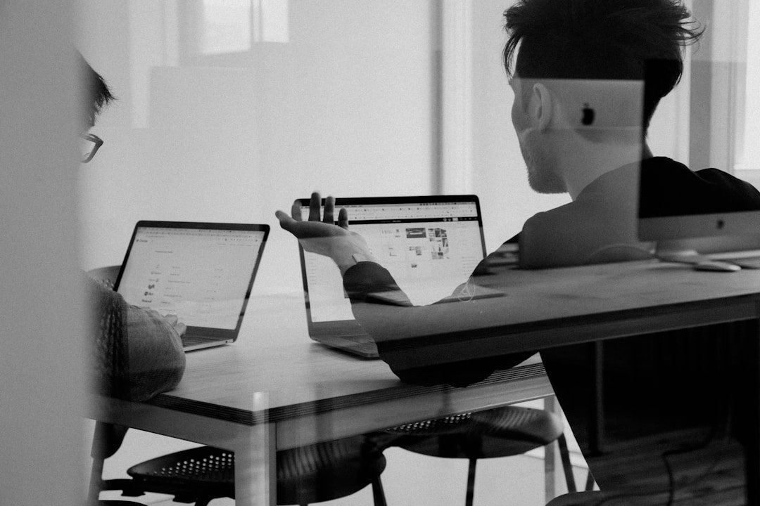 This is an image of Two colleagues on laptop computers discussing customer journey automation for an article called Understanding Customer Journey Automation and Its Importance by octopus competitive intelligence agency octopus market intelligence solutions. Identifying the Areas of Your Business to Automate. Reasons Why Taking a College Course Can Give You a Competitive Edge in Business, How to Create a Learning Management System (LMS): A Comprehensive Guide. Using ERP Systems for Enhanced Competitive Intelligence. Why Faculty Development Is Your School’s Best Marketing Tool